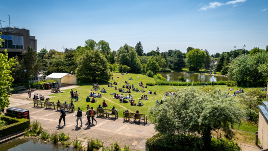Picture of the lakeside at the University of Bath in the sunshine